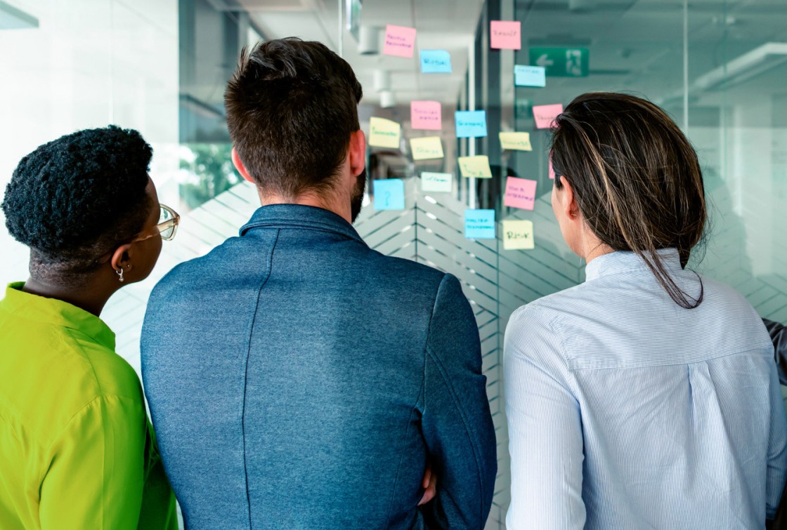 workers looking at sticky notes