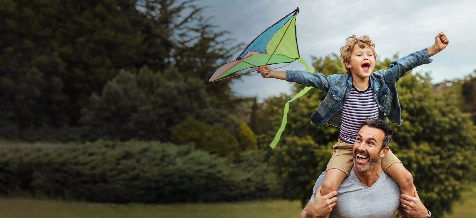 Happy dad and kid flying kite