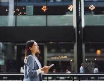 business woman walking outside in busy area