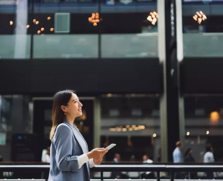 business woman walking outside in busy area