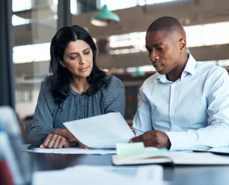 businessman and businesswoman going over paperwork