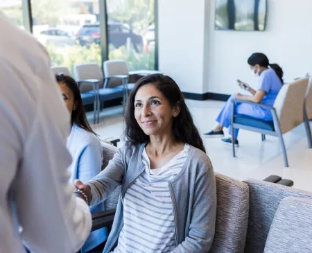 patient in waiting room meeting doctor