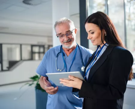 doctor talking and looking at tablet