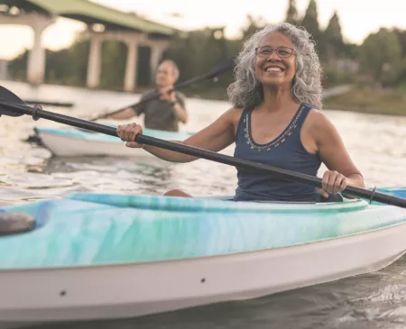 happy older couple kayaking