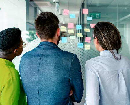 workers looking at sticky notes