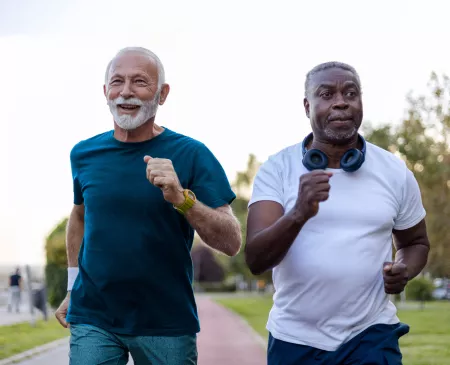 Two elderly men running