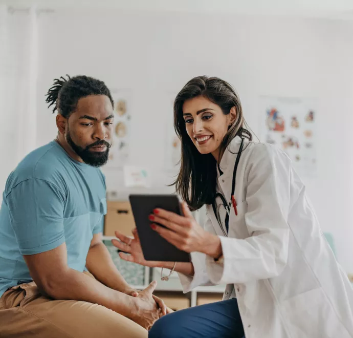 patient and doctor looking at tablet